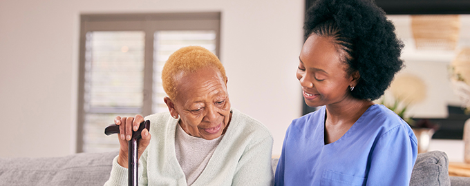 an elderly lady and nurse reading something together